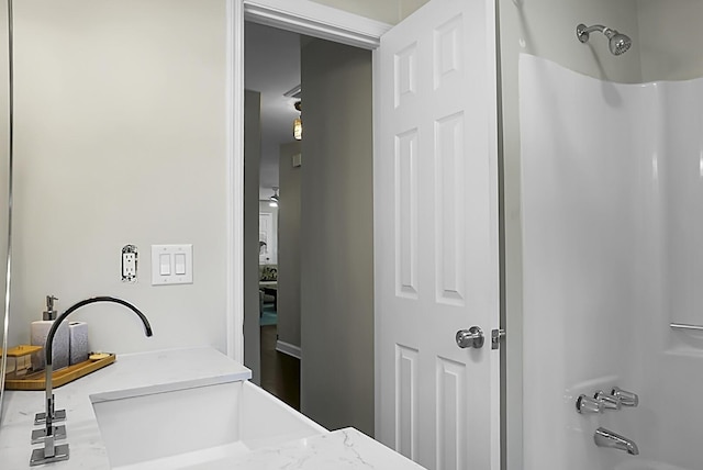 bathroom featuring shower / bath combination and a sink