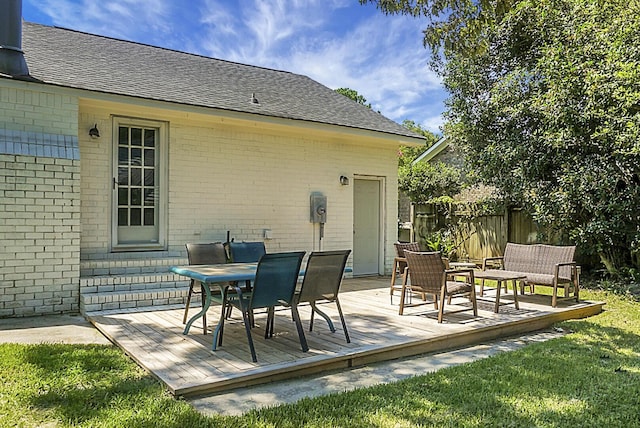 view of patio featuring fence and a deck