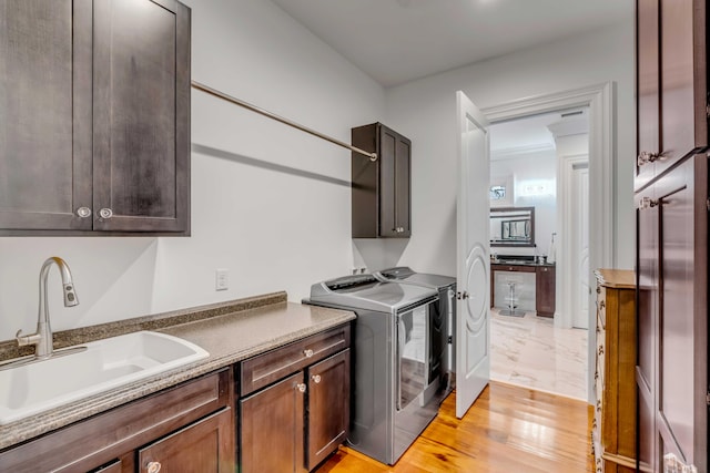 371 Live Palmetto Blf, Mount Pleasant, SC 29464 - washroom with cabinets, light hardwood / wood-style flooring, washer and clothes dryer, and sink
