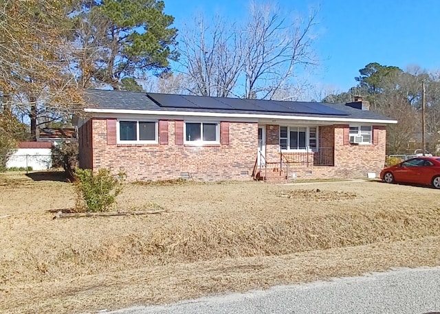 ranch-style home with solar panels