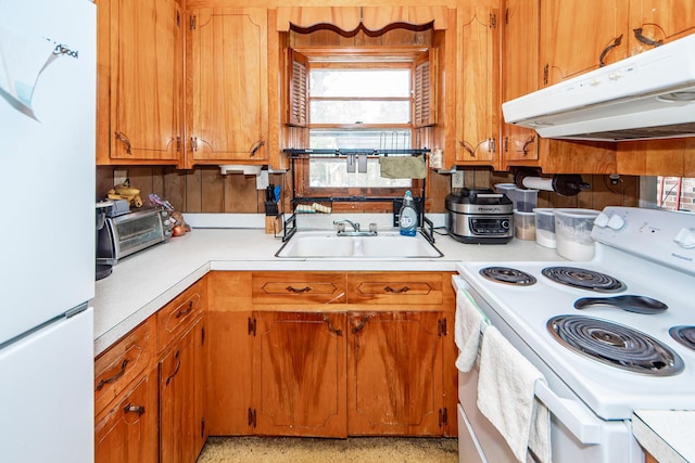 kitchen featuring sink and white appliances