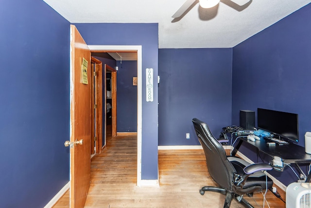 office with ceiling fan and light wood-type flooring