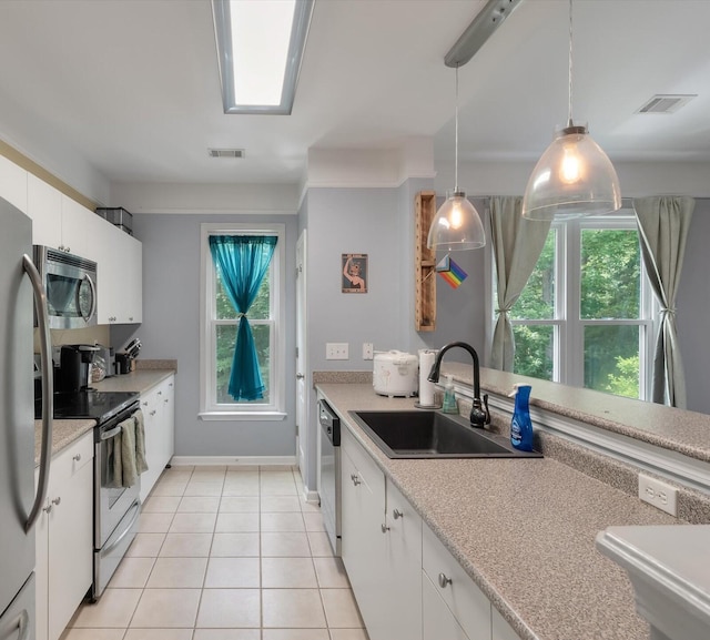 2632 Egret Crest Ln, Charleston, SC 29414 - kitchen featuring stainless steel appliances, a sink, healthy amount of natural light, and white cabinetry