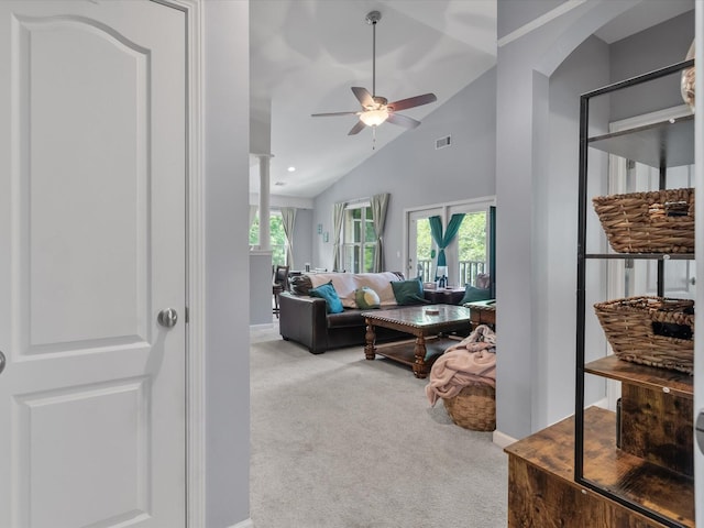 2632 Egret Crest Ln, Charleston, SC 29414 - living room with light carpet, ceiling fan, baseboards, high vaulted ceiling, and arched walkways