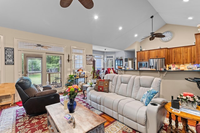 living area with ceiling fan, wood finished floors, healthy amount of natural light, high vaulted ceiling, and recessed lighting
