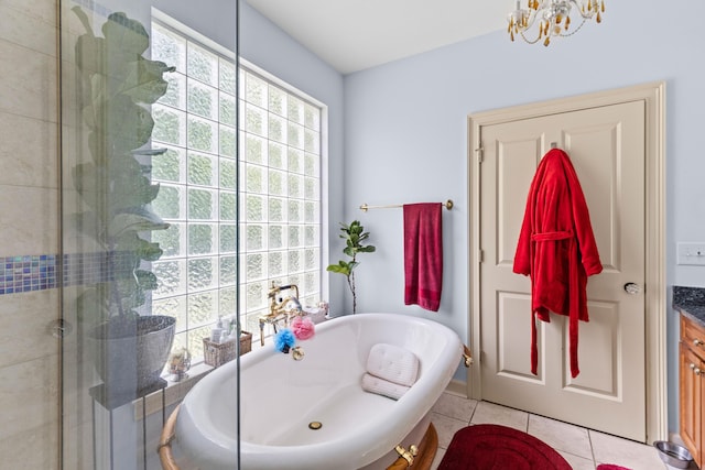 bathroom with a chandelier, a freestanding bath, tile patterned flooring, and a stall shower