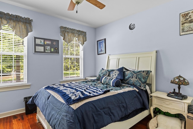 bedroom featuring wood finished floors, baseboards, and a ceiling fan