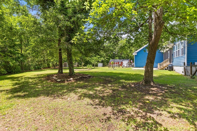 view of grassy yard featuring entry steps