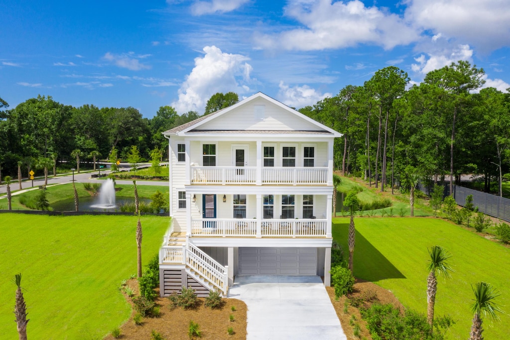 view of front of home with a garage, a balcony, and covered porch