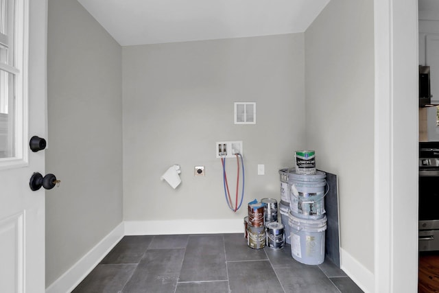 laundry area featuring electric dryer hookup, dark hardwood / wood-style floors, and washer hookup