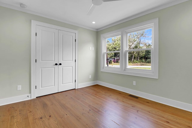 unfurnished bedroom featuring a closet, light wood-type flooring, and ceiling fan