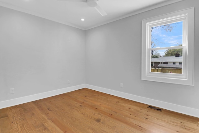 unfurnished room with a wealth of natural light, ceiling fan, and light wood-type flooring