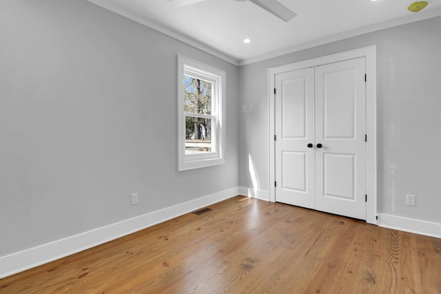 unfurnished bedroom with light hardwood / wood-style flooring, a closet, and ceiling fan