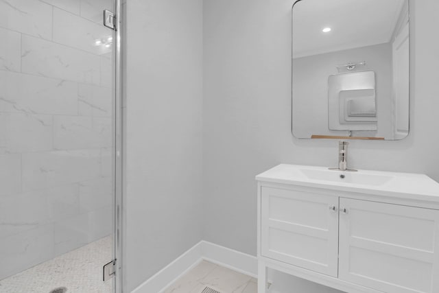 bathroom with tile patterned flooring, vanity, and a tile shower