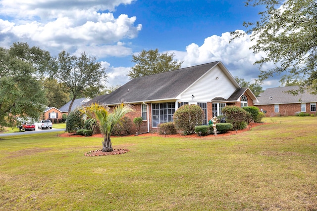 view of side of home with a lawn