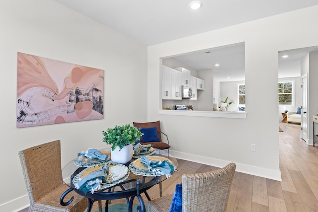 dining room featuring recessed lighting, baseboards, and light wood finished floors