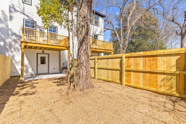 view of yard featuring fence and a deck