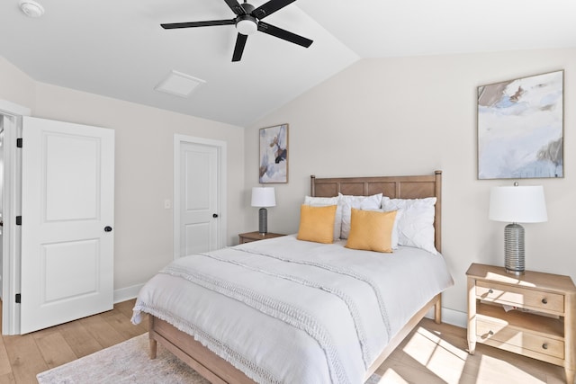 bedroom featuring lofted ceiling, light wood finished floors, ceiling fan, and baseboards