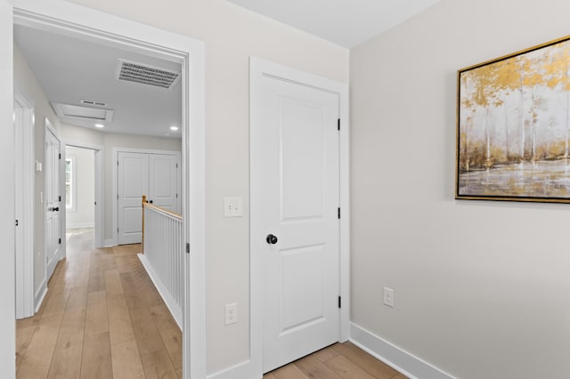 hall with recessed lighting, visible vents, light wood-style flooring, attic access, and baseboards