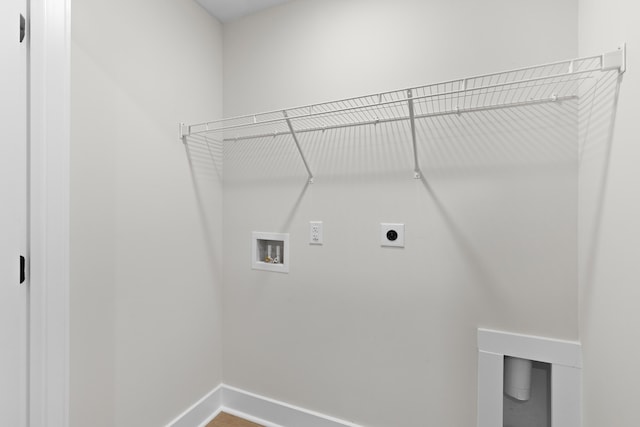 laundry area with baseboards, laundry area, hookup for a washing machine, and hookup for an electric dryer