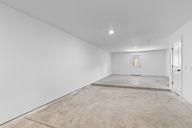 spare room featuring unfinished concrete floors