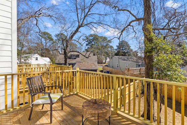 wooden terrace featuring fence and a residential view