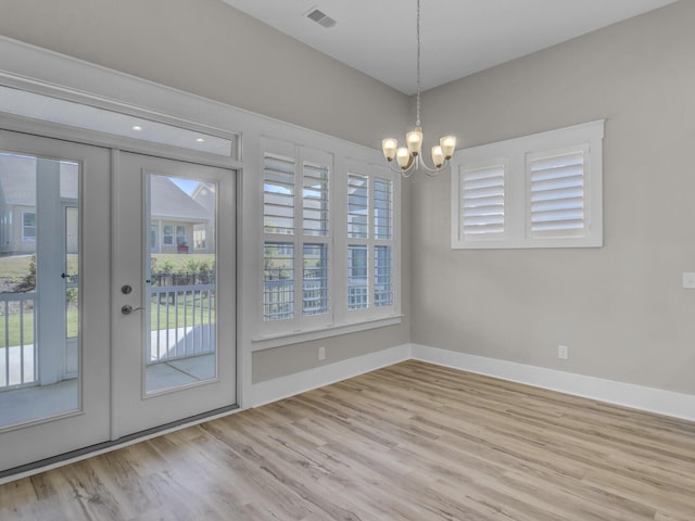 253 River Martin Ct, Summerville, SC 29483 - unfurnished dining area with french doors, a chandelier, wood finished floors, baseboards, and visible vents