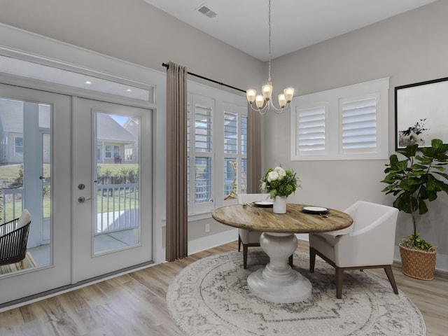 253 River Martin Ct, Summerville, SC 29483 - dining space with light wood-type flooring, french doors, baseboards, visible vents, and a notable chandelier