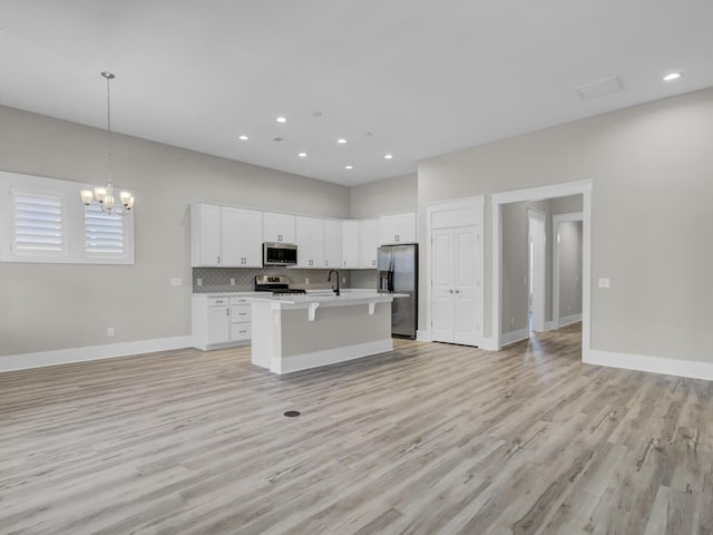 253 River Martin Ct, Summerville, SC 29483 - kitchen with open floor plan, light countertops, a notable chandelier, and appliances with stainless steel finishes