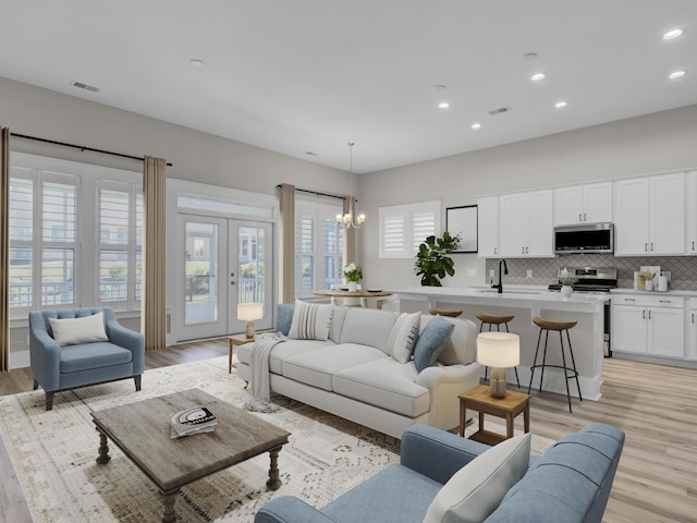 253 River Martin Ct, Summerville, SC 29483 - living area featuring recessed lighting, french doors, light wood finished floors, visible vents, and a notable chandelier