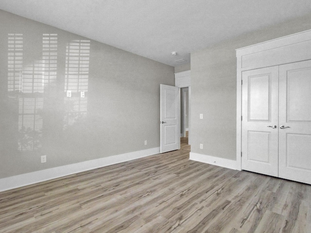 253 River Martin Ct, Summerville, SC 29483 - unfurnished bedroom with a closet, baseboards, and wood finished floors