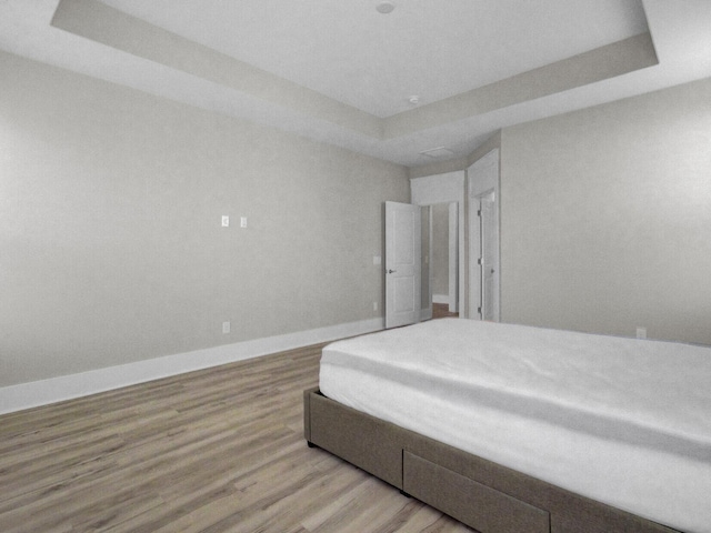 253 River Martin Ct, Summerville, SC 29483 - bedroom featuring a raised ceiling, baseboards, and wood finished floors