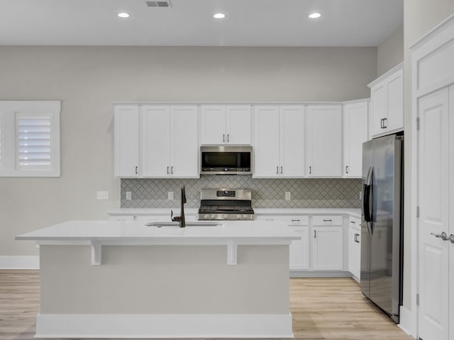 253 River Martin Ct, Summerville, SC 29483 - kitchen featuring white cabinetry, light countertops, a sink, and stainless steel appliances