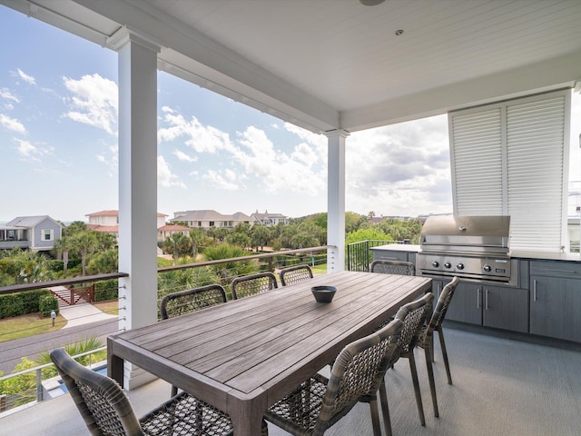 view of patio featuring exterior kitchen, outdoor dining space, and a grill