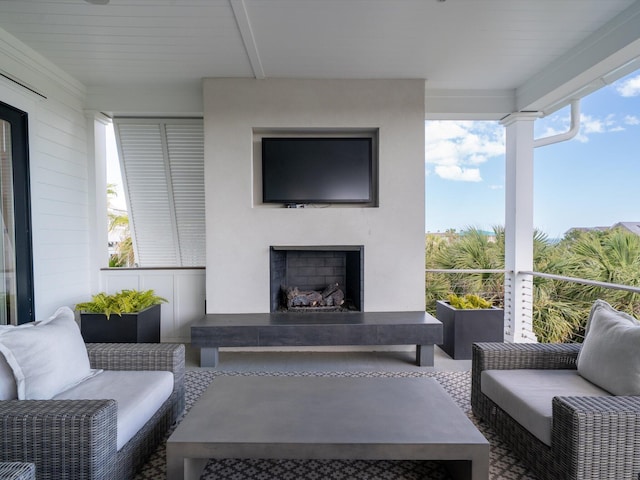 balcony with an outdoor living space with a fireplace