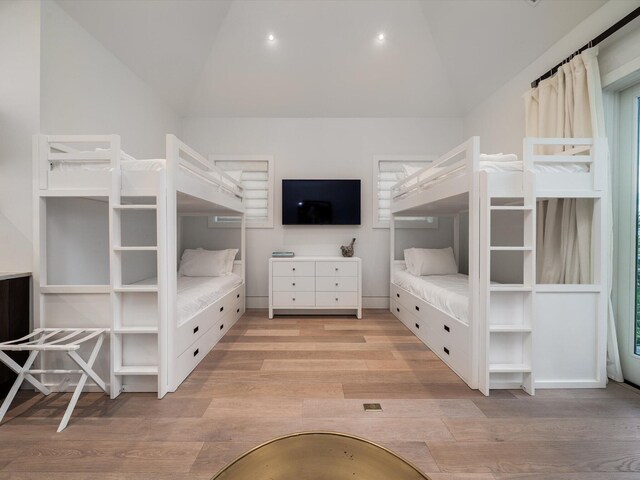 unfurnished bedroom featuring light wood-style floors, vaulted ceiling, and recessed lighting