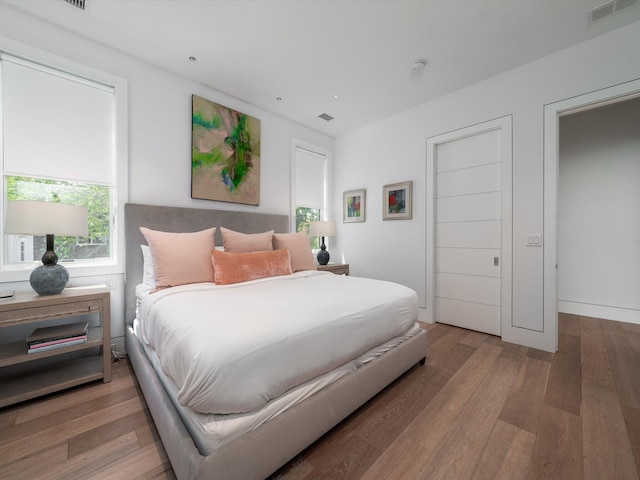 bedroom with wood finished floors and visible vents