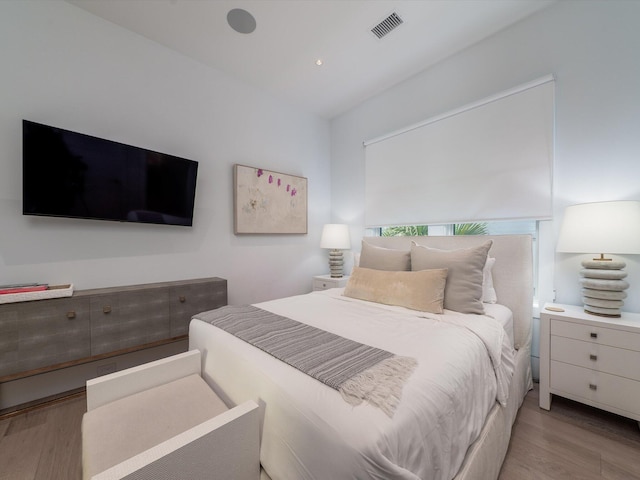 bedroom featuring visible vents and wood finished floors