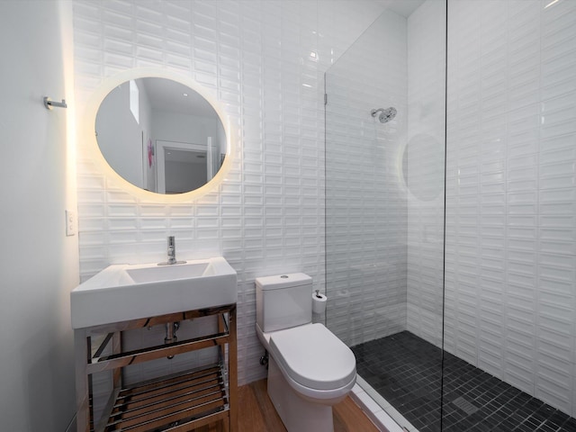 full bath featuring toilet, tile walls, and a tile shower