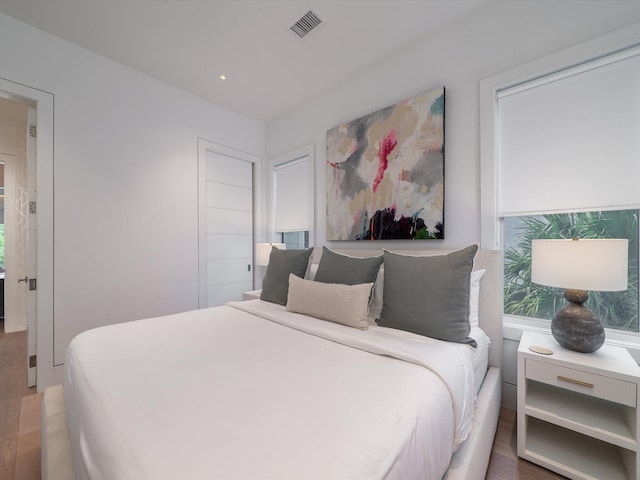 bedroom featuring recessed lighting, visible vents, and wood finished floors