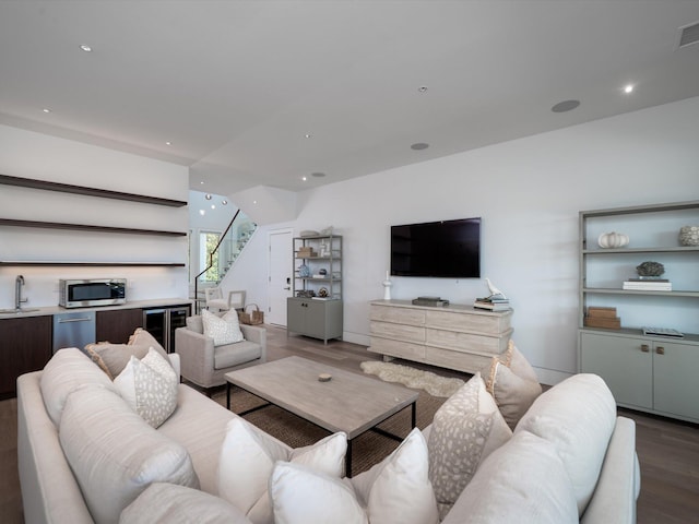 living area with visible vents, wood finished floors, stairway, wine cooler, and recessed lighting