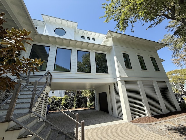 view of front of home with a carport and stairway