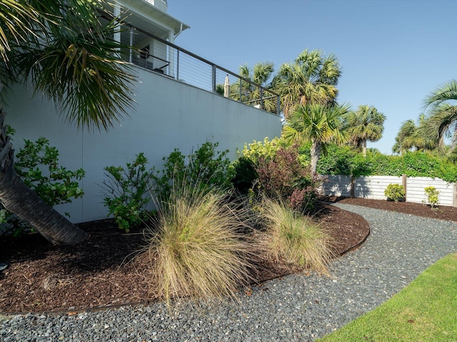 view of yard with fence and a balcony