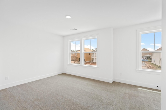 empty room featuring carpet flooring and a healthy amount of sunlight