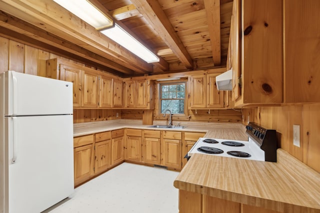 kitchen featuring sink, electric range, white fridge, exhaust hood, and wood walls