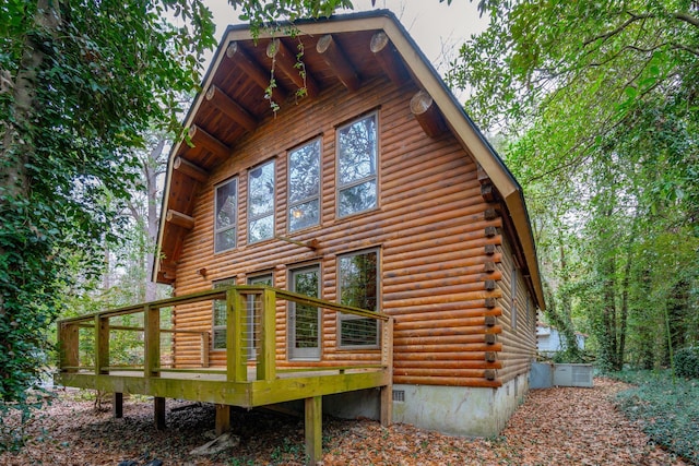 back of property featuring a wooden deck