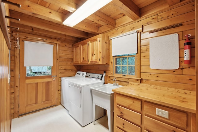 laundry area featuring cabinets, washing machine and dryer, wooden ceiling, and wooden walls