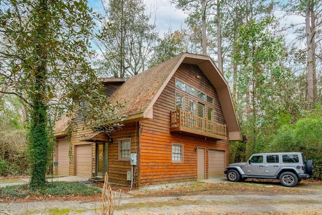 view of front facade with a garage and a balcony