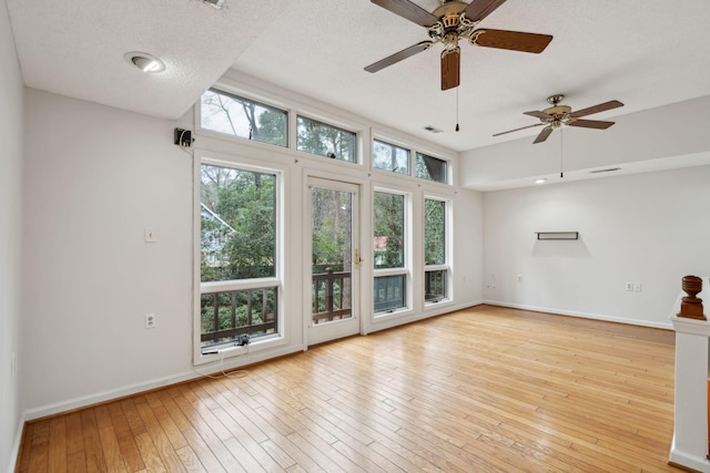 empty room featuring light hardwood / wood-style floors and a textured ceiling