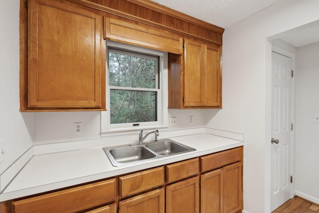 kitchen with sink and a textured ceiling